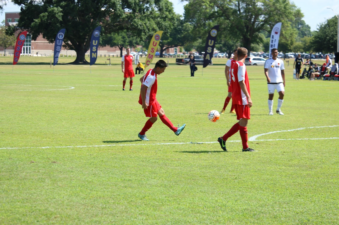 Fort Benning, Ga. - Marine Cpl Alexander Figueroa-Roncon chips a goal over a wall of Army defenders to put the Marines on the board in the consolation match of the 2016 Armed Forces Men's Soccer Championship hosted at Fort Benning, Ga from 6-14 May 2016.  Marine Corps would go on to win the contest 3-2 to take third place.