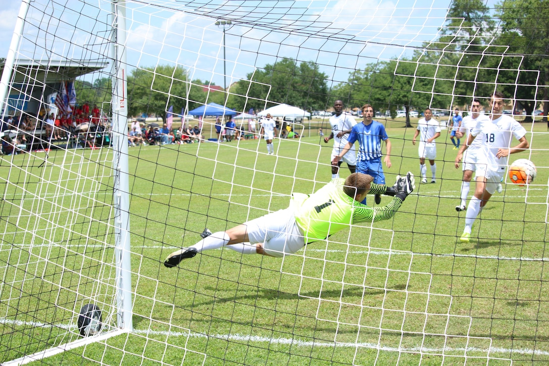 Fort Benning, Ga. - Navy goalkeeper PO3 Raymond Craddock (#1) attempts to block the kick of Air Force 2nd Lt Micah Cummins (not seen) to break the tie of the championship match of the 2016 Armed Forces Men's Soccer Championship hosted at Fort Benning, Ga from 6-14 May 2016.  Air Force would win the Championship 3-2, with Navy taking silver.