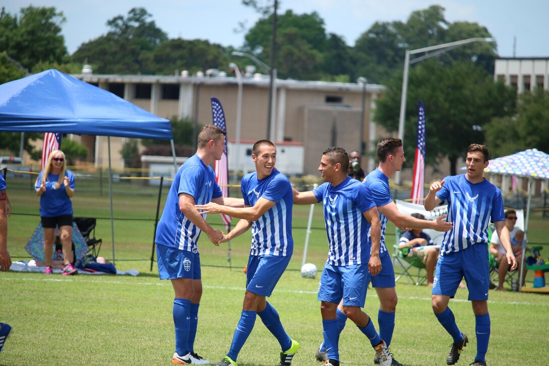 Fort Benning, Ga. - Air Force A1C Benjamin Latimer (second from left) celebrates with his teammates after his goal, raising the score to 3-1 in the championship match of the 2016 Armed Forces Men's Soccer Championship hosted at Fort Benning, Ga from 6-14 May 2016.  Air Force would win the Championship 3-2, with Navy taking silver.