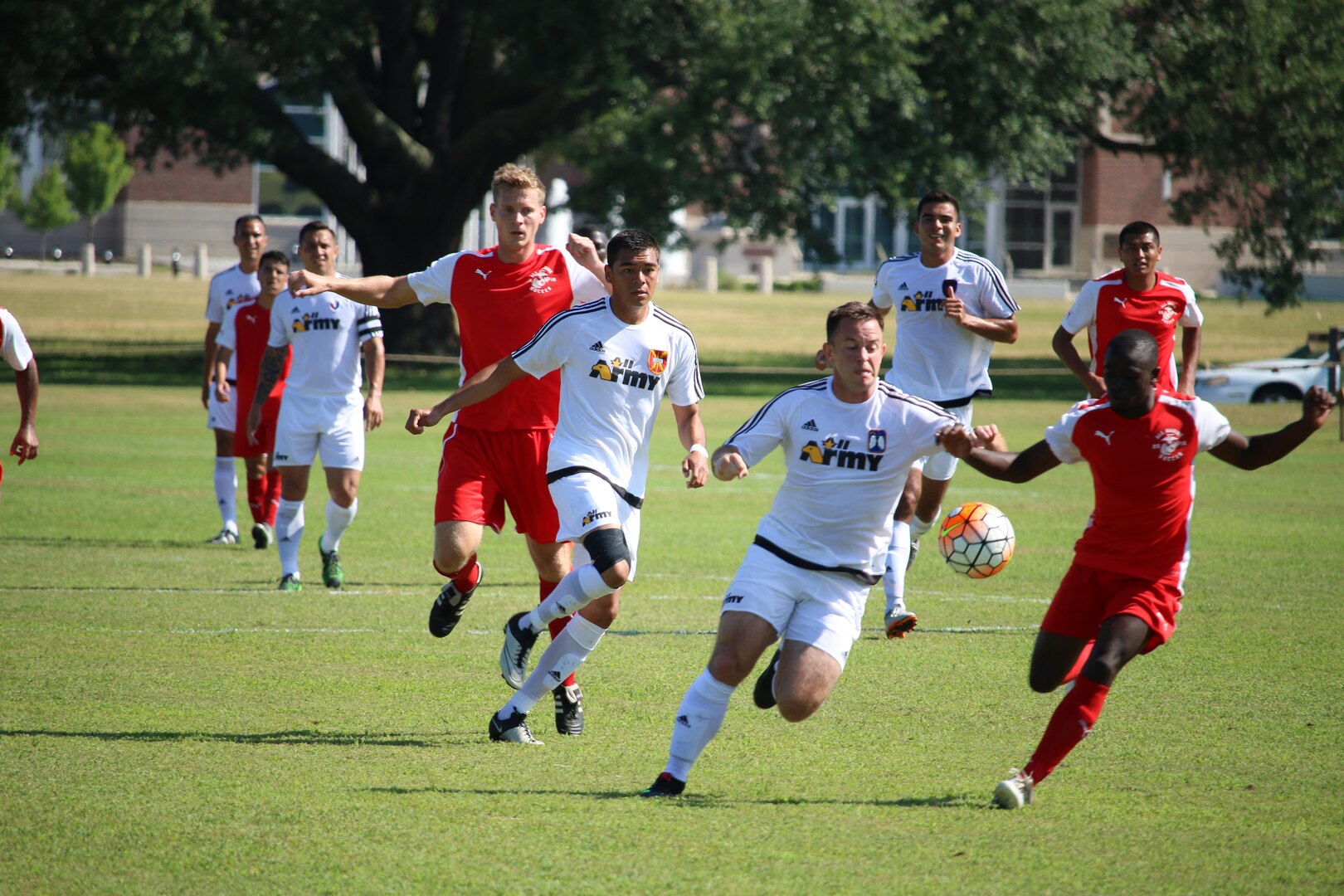 Fort Benning, Ga. - Army Capt Andrew Hyres (center with ball) drives down the field on the opening 30 seconds of the match to put Army on the board 1-0 of the consolation match of the 2016 Armed Forces Men's Soccer Championship hosted at Fort Benning, Ga from 6-14 May 2016.  Marine Corps would win the match 3-2, placing them third overall and Army in fourth.