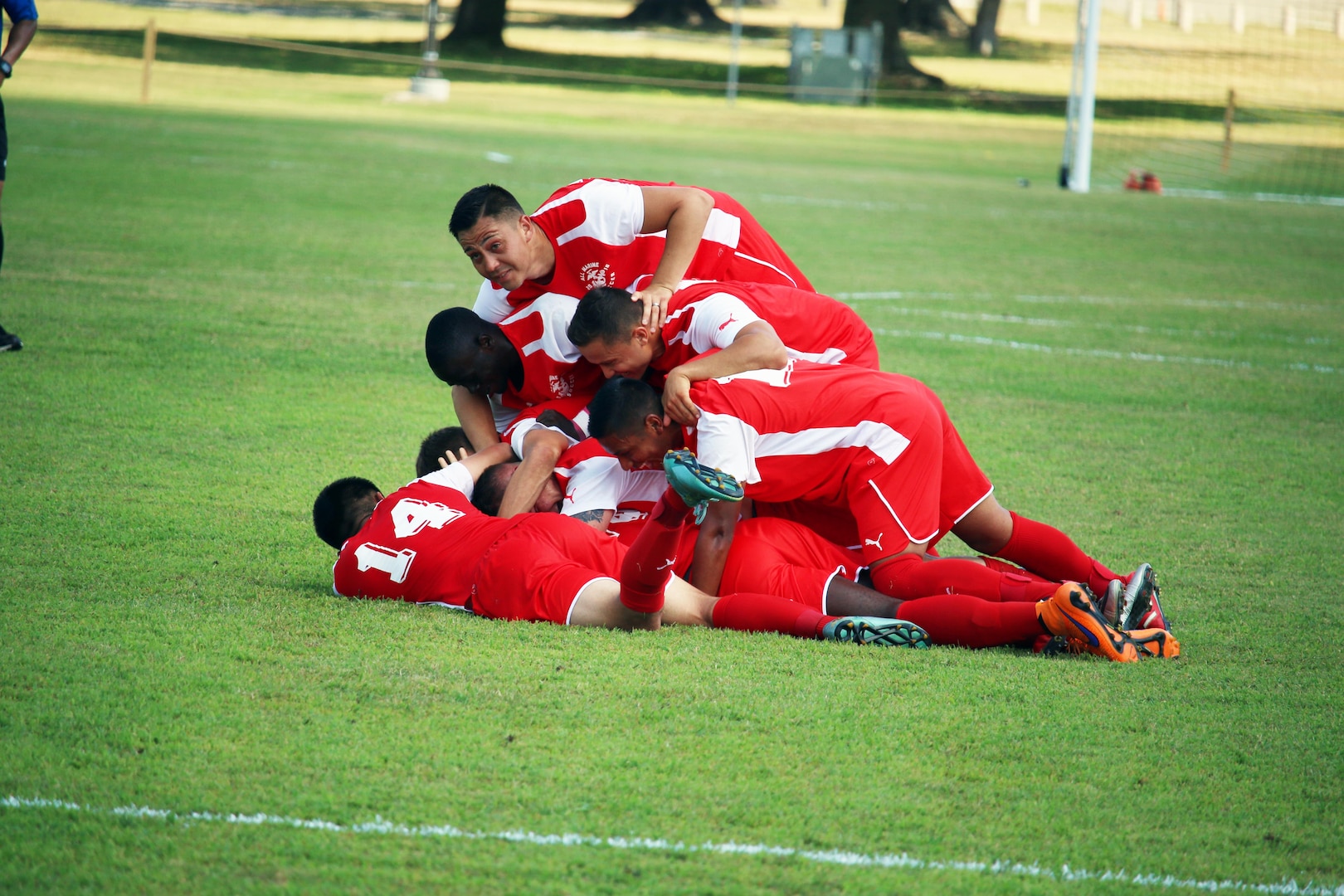 Fort Benning, Ga. - Marine Corps players celebrate after the game winning goal by Cpl Juan Medina (somewhere on the bottom) in the consolation match of the 2016 Armed Forces Men's Soccer Championship hosted at Fort Benning, Ga from 6-14 May 2016.  Marine Corps would go on to win the contest 3-2 to take third place.