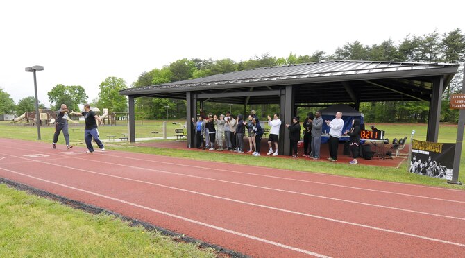 Members of the 459th cheer on their fellow wingmen during a Holocaust Remembrance Month run at the Virginia Track on Joint Base Andrews May 9. More than a dozen volunteers from the 459th came out to support the 24-hour vigil run, which started May 9 at 8:30 a.m. and ended May 10th at 8:30 a.m. (U.S. Air Force photo by Staff Sgt. Kat Justen)