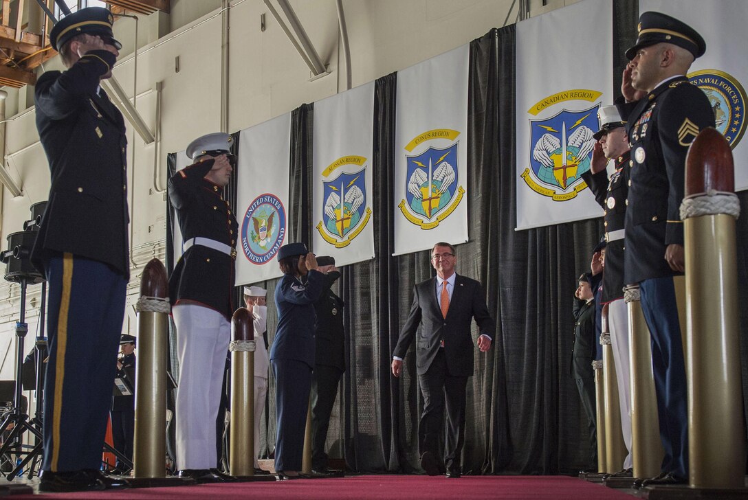 Service members salute as Defense Secretary Ash Carter enters during the change-of-command ceremony for the North American Aerospace Defense Command and U.S. Northern Command at Peterson Air Force Base, Colo., May 13, 2016. DoD photo by Air Force Senior Master Sgt. Adrian Cadiz