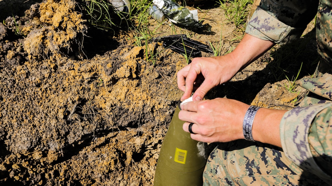 A Marine with 2nd Explosive Ordnance Disposal Company packs C4 into a M107 155mm projectile during a Protective Works Demolition Range at Marine Corps Base Camp Lejeune, North Carolina, May 12, 2016. Approximately 20 EOD technicians participated in the training event to rehearse protocol and experiment with new procedures that allow them to reduce the effects of an explosion. 