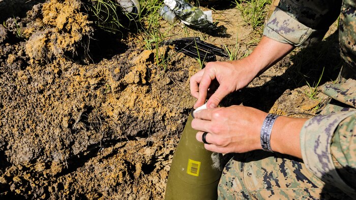 A Marine with 2nd Explosive Ordnance Disposal Company packs C4 into a M107 155mm projectile during a Protective Works Demolition Range at Marine Corps Base Camp Lejeune, North Carolina, May 12, 2016. Approximately 20 EOD technicians participated in the training event to rehearse protocol and experiment with new procedures that allow them to reduce the effects of an explosion. 