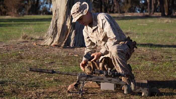 Cpl. John Luze, a competitor with the Marine Corps Shooting Team, loads a magazine before a practice fire with his M40A5 sniper rifle at Puckpunyal Military Area in Victoria, Australia, May 7, 2016. The M40A5 is a bolt-action sniper rifle that the Marine Corps uses for long-range enemy engagements.