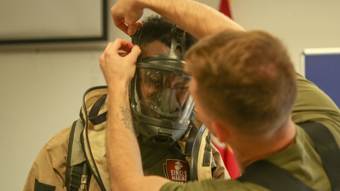 A Marine with the Chemical Biological Radiological and Nuclear (CBRN) unit receives assistance putting on a hazardous material suit during Assessment Consequence Management training at Marine Corps Air Station Miramar, California, May 6. The ACM training is conducted by CBRN once a month to maintain mission readiness. 