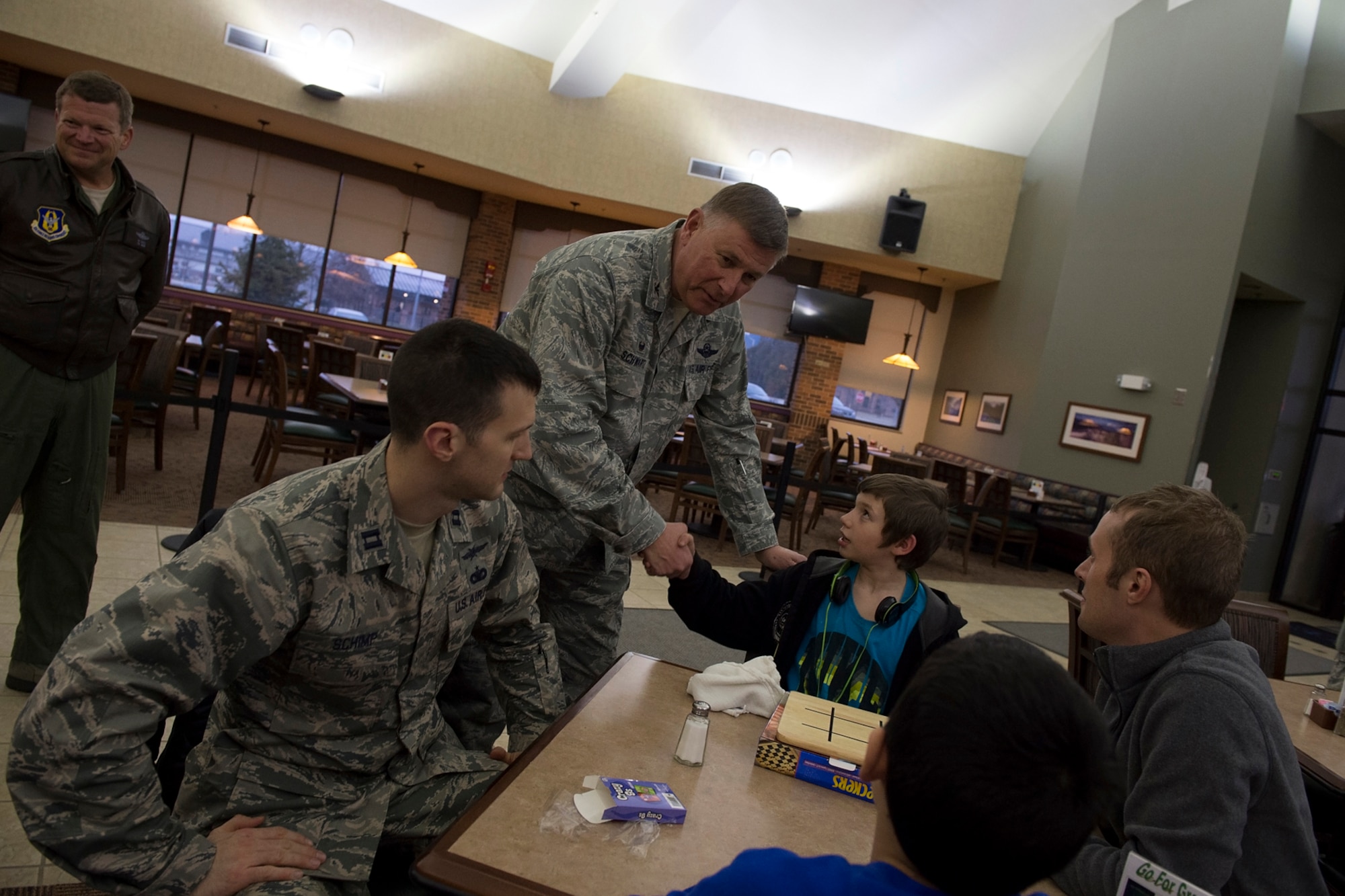 Col. Doug Schwartz, 434th Air Refueling Wing commander, shakes hands with Dawson Miller, a Cass County Big Brother Big Sister participant during a BBBS event held here March 5, 2016. The program is being held here each Saturday during the unit training assembly to help foster positive relationships and mentorship to young lives.  (U.S. Air Force/ Staff Sgt. Jami K. Lancette) 