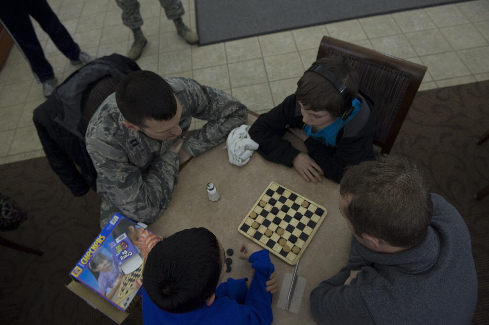 Capt. Dustin Schimp, 434th Communications Squadron director of operations and Staff Sgt. Paul Harrington, 434th Communications Squadron cyber transport craftsman play a game of checkers with their “littles” during a Big brother Big Sister event held here March 5. The program is being held here each Saturday during the unit training assembly to help foster positive relationships and mentorship to young lives. (U.S. Air Force/ Staff Sgt. Jami K. Lancette) 