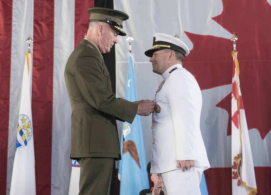 Marine Corps Gen. Joe Dunford, chairman of the Joint Chiefs of Staff, awards Navy Adm. Bill Gortney a Defense Distinguished Service Medal during the change-of-command ceremony for the North American Aerospace Defense Command and U.S. Northern Command at Peterson Air Force Base, Colo., May 13, 2016. Gortney relinquished command of NORAD and Northcom to Air Force Gen. Lori J. Robinson during the event. DoD photo by Navy Petty Officer 2nd Class Dominique A. Pineiro