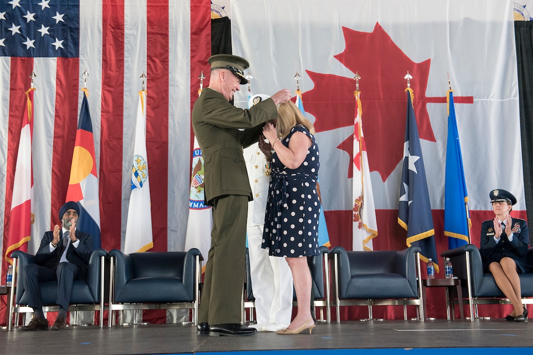 Marine Corps Gen. Joe Dunford, chairman of the Joint Chiefs of Staff, presents a Defense Department Medal for Distinguished Public Service to Sherry Gortney, wife of Navy Adm. Bill Gortney, during the change-of-command ceremony for the North American Aerospace Defense Command and U.S. Northern Command at Peterson Air Force Base, Colo., May 13, 2016. DoD photo by Navy Petty Officer 2nd Class Dominique A. Pineiro