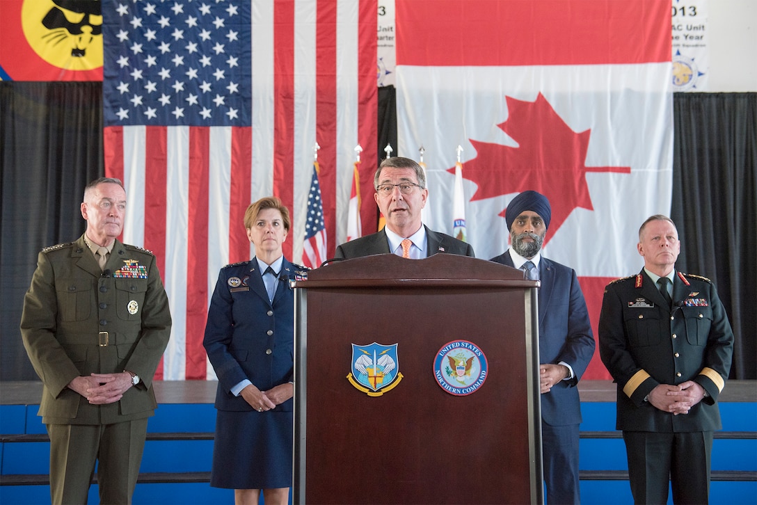 Defense Secretary Ash Carter speaks during a press conference following a change-of-command ceremony for the North American Aerospace Defense Command and U.S. Northern Command at Peterson Air Force Base, Colo., May 13, 2016. Air Force Gen. Lori J. Robinson, second from left, assumed command of NORAD and Northcom during the ceremony. Also pictured are, from left, Marine Corps Gen. Joe Dunford, chairman of the Joint Chiefs of Staff; Canadian Defense Minister Harjit Sajjan; and Canadian Army Gen. Jonathan Vance, chief of the Canadian defense staff. DoD photo by Navy Petty Officer 2nd Class Dominique A. Pineiro