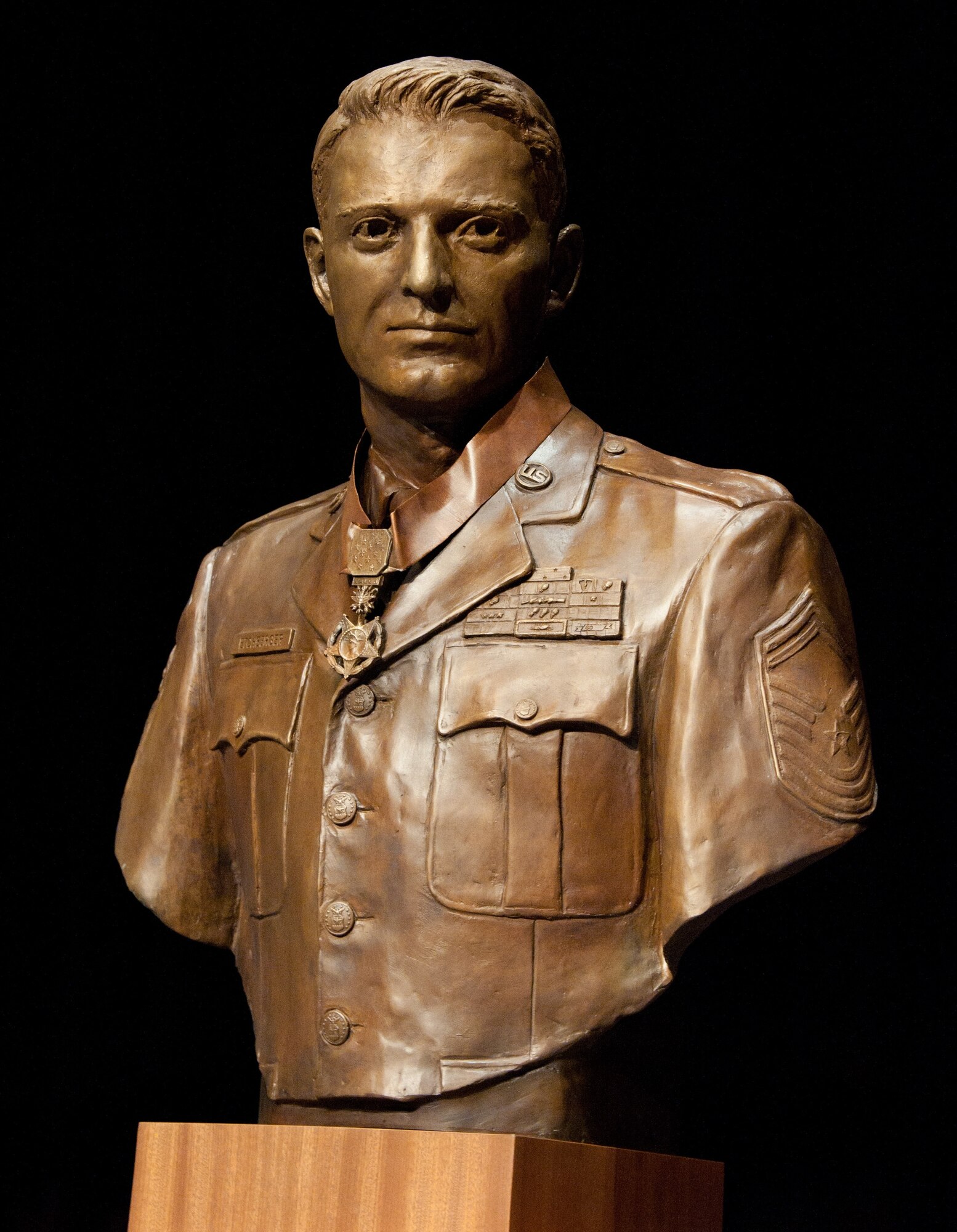 A bust of Medal of Honor recipient Chief Master Sgt. Richard L. Etchberger shines onstage at the Air Force Senior Noncommissioned Officer Academy during its March 26, 2012, dedication. Sculpted by artist John Lajba, the bust is part of the permanent exhibit at the academy. (U.S. Air Force photo by Melanie Rodgers Cox)
 
