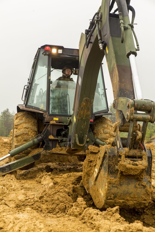 Lance Cpl. Austin Bradford, a heavy equipment operator with Marine Wing Support Squadron 171, engineer company, heavy equipment platoon, digs a fighting hole during exercise Thunder Horse 16.2 at the Japan Ground Self-Defense Force’s Haramura Maneuver Area in Hiroshima, Japan, May 12, 2016. The week-long exercise focused on reinforcing skills that Marines learned throughout their military occupational specialty schooling and during Marine Combat Training in order to maintain situational readiness. Heavy equipment operators and combat engineers dug fighting holes for defensive positions, provided mechanical and road clearance with a bulldozer, conducted vehicle recovery, participated in security patrols and established a forward operating base. (U.S. Marine Corps photo by Lance Cpl. Aaron Henson/Released)
