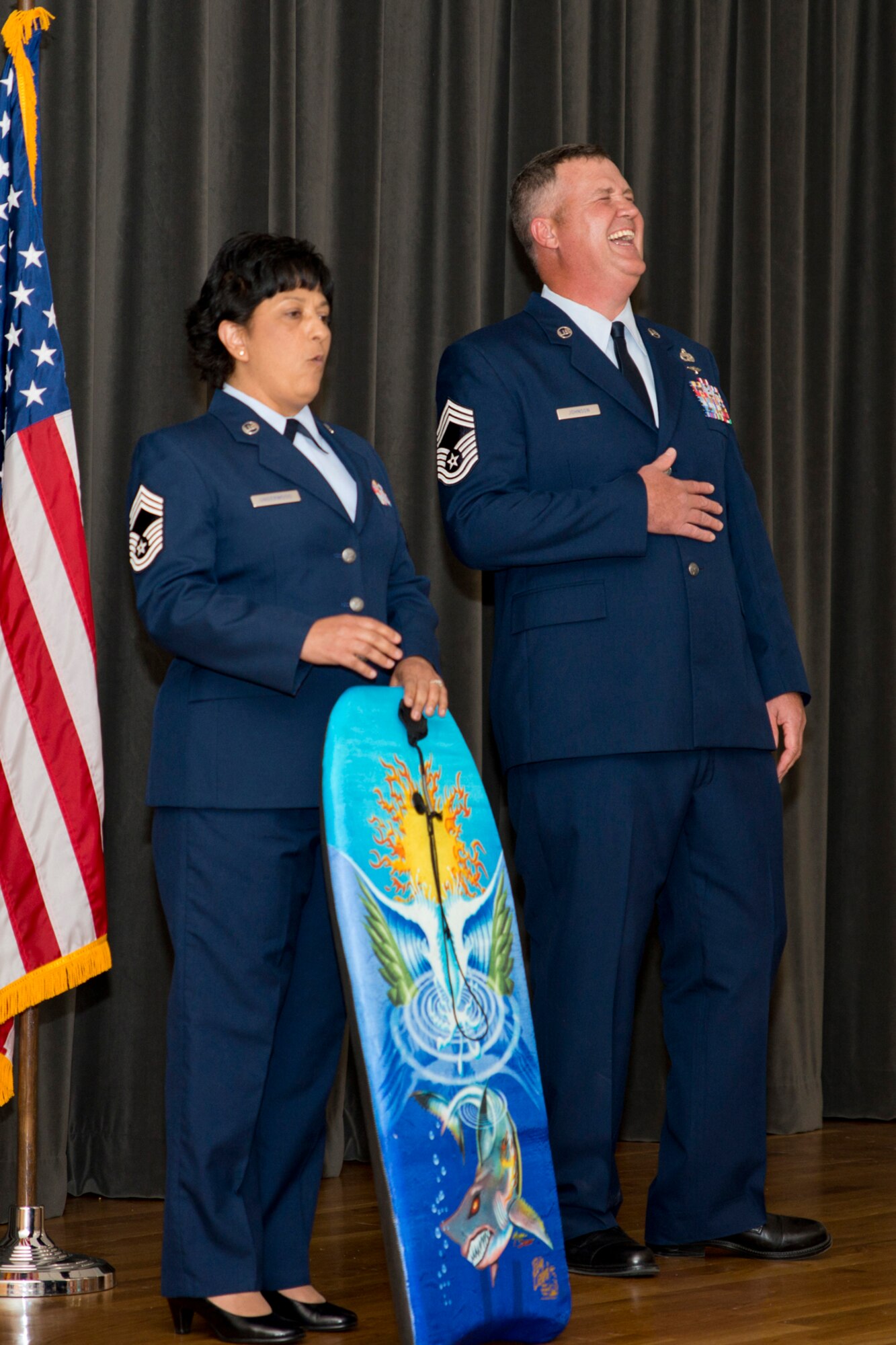 U.S. Air Force Reserve Chief Master Sgt. Cynthia Underwood, superintendent, 96th Aerial Port Squadron, reflects on the career of Retired Chief Master Sgt. Todd Johnson, during his retirement ceremony at Little Rock Air Force Base, Ark., May 14, 2016. Johnson retired after 28 years of faithful service to his country in a room filled with family, friends and co-workers. (U.S. Air Force photo by Master Sgt. Jeff Walston/Released)     
