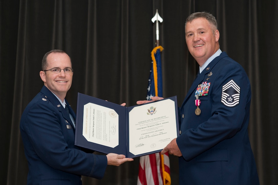 U.S. Air Force Reserve Lt. Col. Jason Sheridan, commander, 96th Aerial Port Squadron, poses for a photo with Retired Chief Master Sgt. Todd Johnson, during his retirement ceremony at Little Rock Air Force Base, Ark., May 14, 2016. Described as an Icon, Johnson retired after 28 years of faithful service to his country in a room filled with family, friends and co-workers. (U.S. Air Force photo by Master Sgt. Jeff Walston/Released)     

