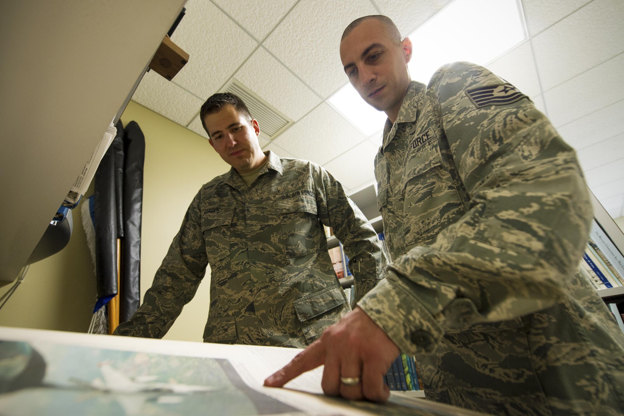 Staff Sgt. Mike Ziadeh, left, and Tech. Sgt. Andrew Carr, 434th Air Refueling Wing historians, reorganize historical documents at Grissom Air Reserve Base, Indiana, April 9, 2016. Ziadeh and Carr recently joined the 434th ARW as the new historians, filling in the shoes of a three-year vacant position. (U.S. Air Force photo/Staff Sgt. Katrina Heikkinen) 