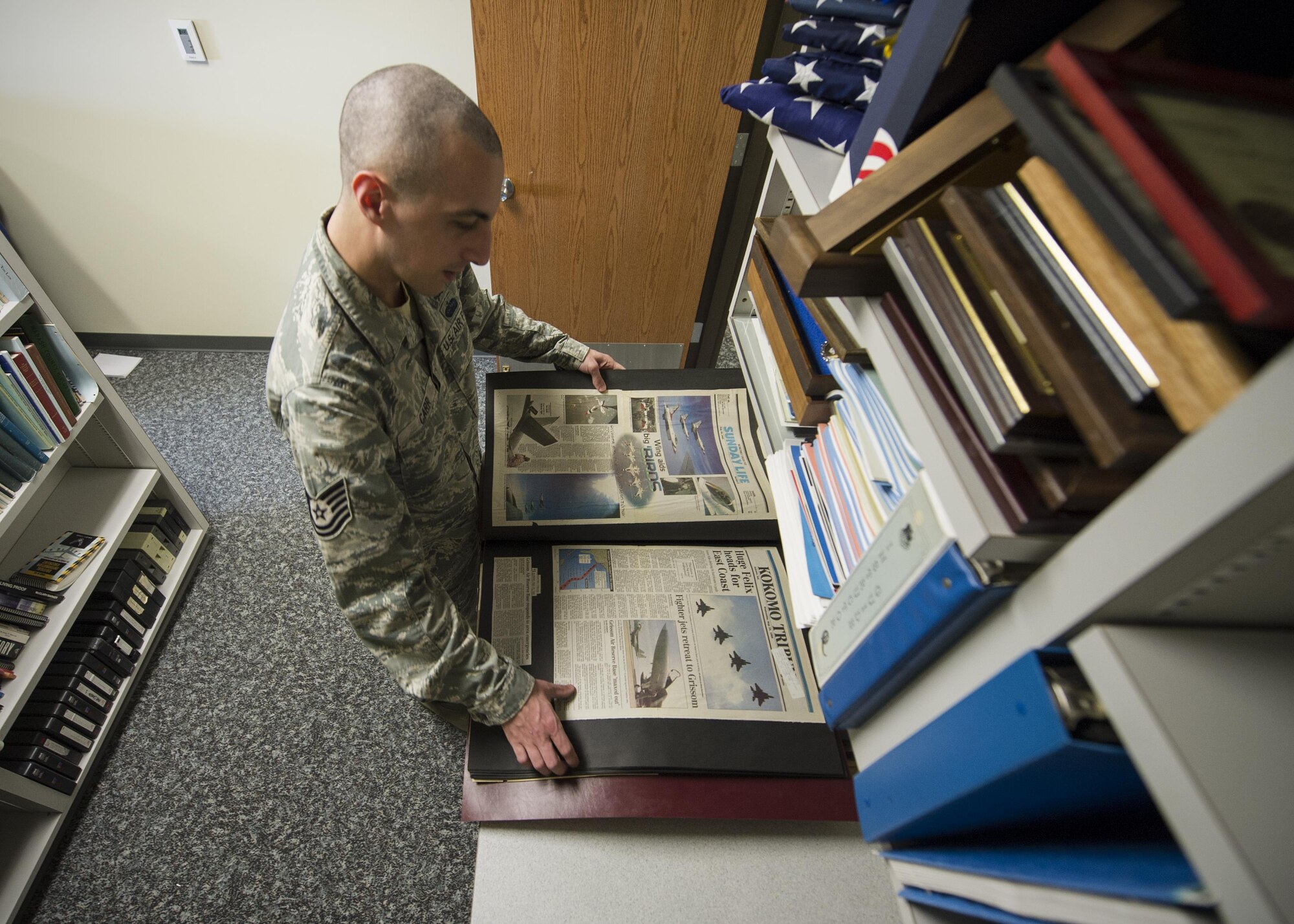 Tech. Sgt. Andrew Carr, 434th Air Refueling Wing historian, reviews clippings from a Kokomo Tribune featuring the 434th ARW at Grissom Air Reserve Base, Indiana, April 9, 2016.  Carr transitioned from active-duty to the Reserve in August 2015 and served as a cyber surety technician for 11 years. (U.S. Air Force photo/Staff Sgt. Katrina Heikkinen)
