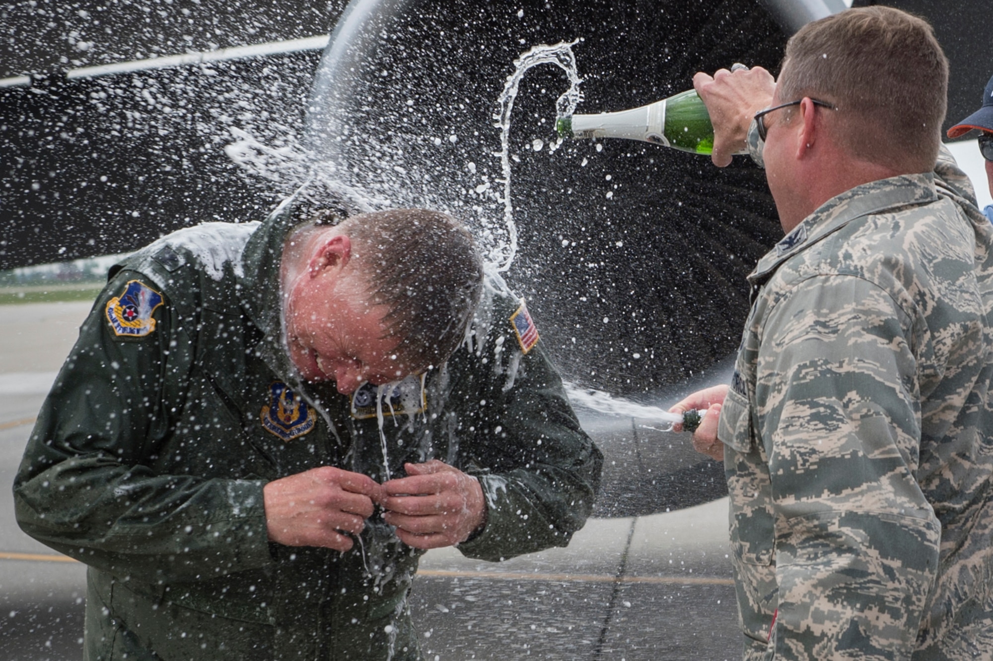 Col. Doug Schwartz, 434th Air Refueling Wing commander, gets a champagne shower upon landing at Grissom Air Reserve Base, Ind., May 13, 2016. The flight was Schwartz’s last as he retired after 35 years of military service. (U.S. Air Force photo/Tech. Sgt. Benjamin Mota)