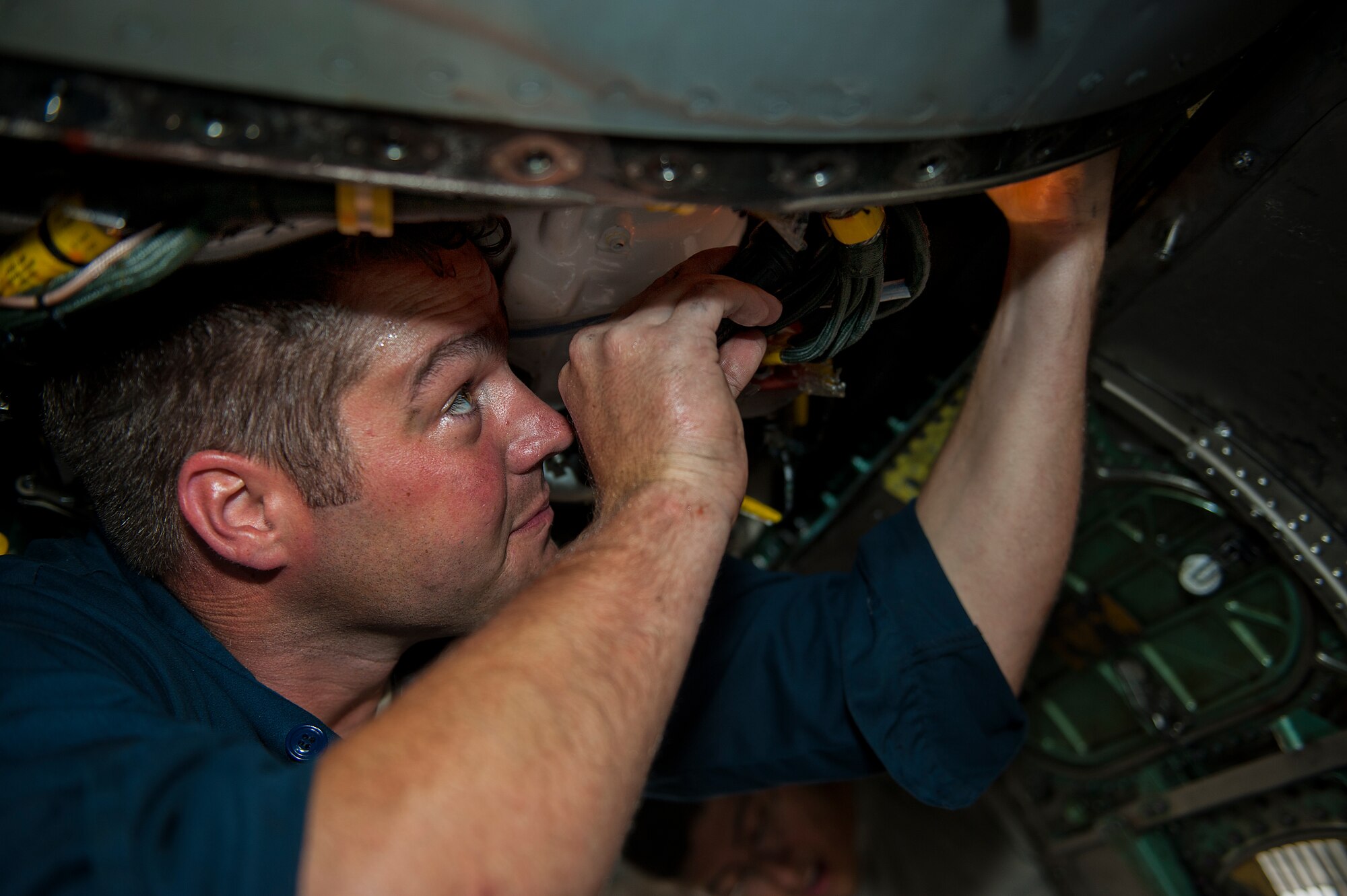 U.S. Air Force Staff Sgt. Carl Petmecky, 44th Aircraft Maintenance Unit dedicated crew chief, looks to find the source of a leak on an F-15E Eagle May 11, 2016, at Kadena Air Base, Japan. Crew chiefs are responsible for fixing broken parts, as well as the general maintenance of the aircraft. (U.S. Air Force photo by Airman 1st Class Corey M. Pettis)