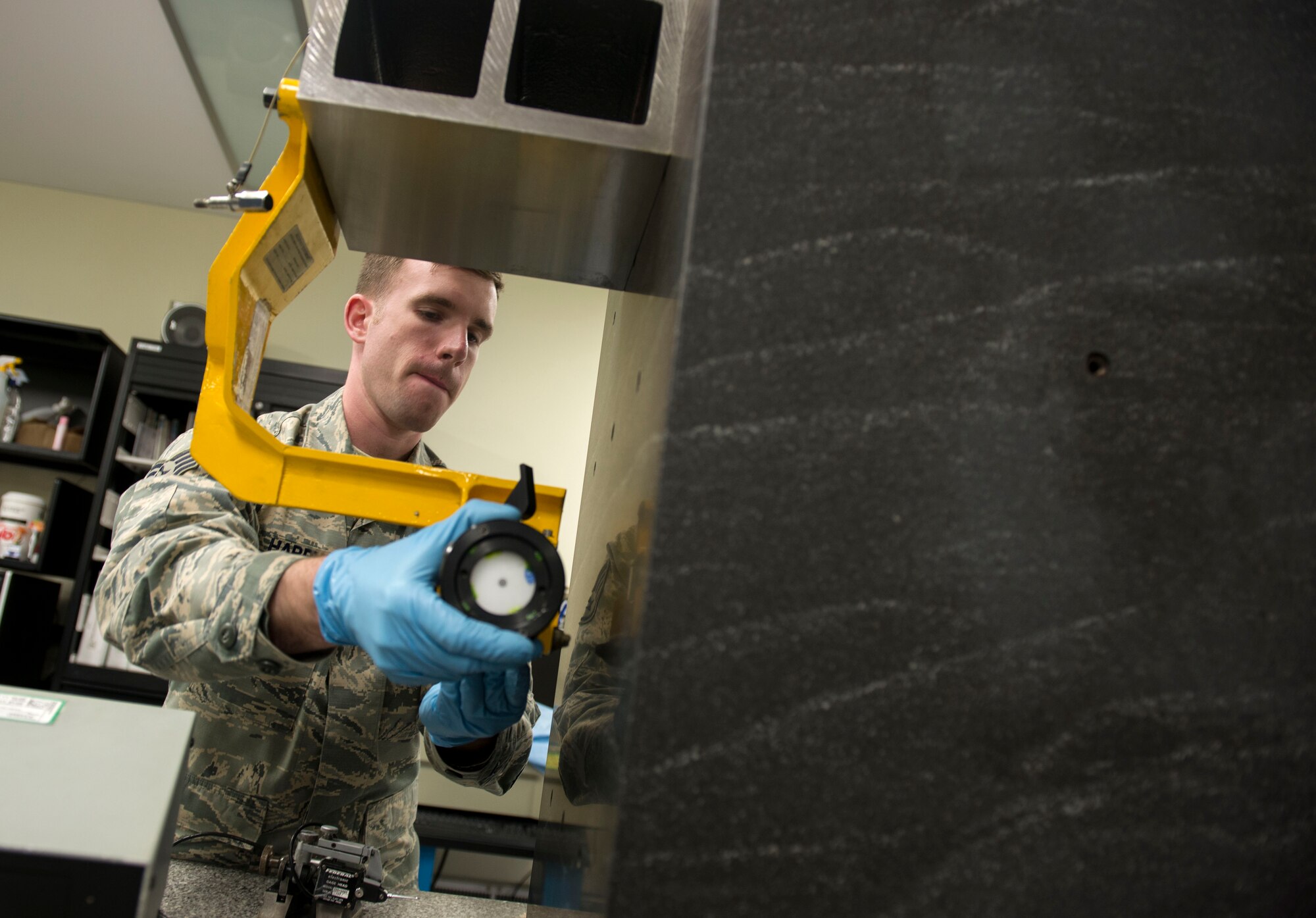 U.S. Air Force Staff Sgt. Benjamin Harvey, 18th Component Maintenance Squadron test, measurement and diagnostic equipment element supervisor, inspects the insides of equipment used to align the guns of the F-15 Eagle at May 10, 2016, at Kadena, Japan. The time it takes to inspect and calibrate equipment can range from minutes to weeks. (U.S. Air Force photo by Senior Airman Omari Bernard)