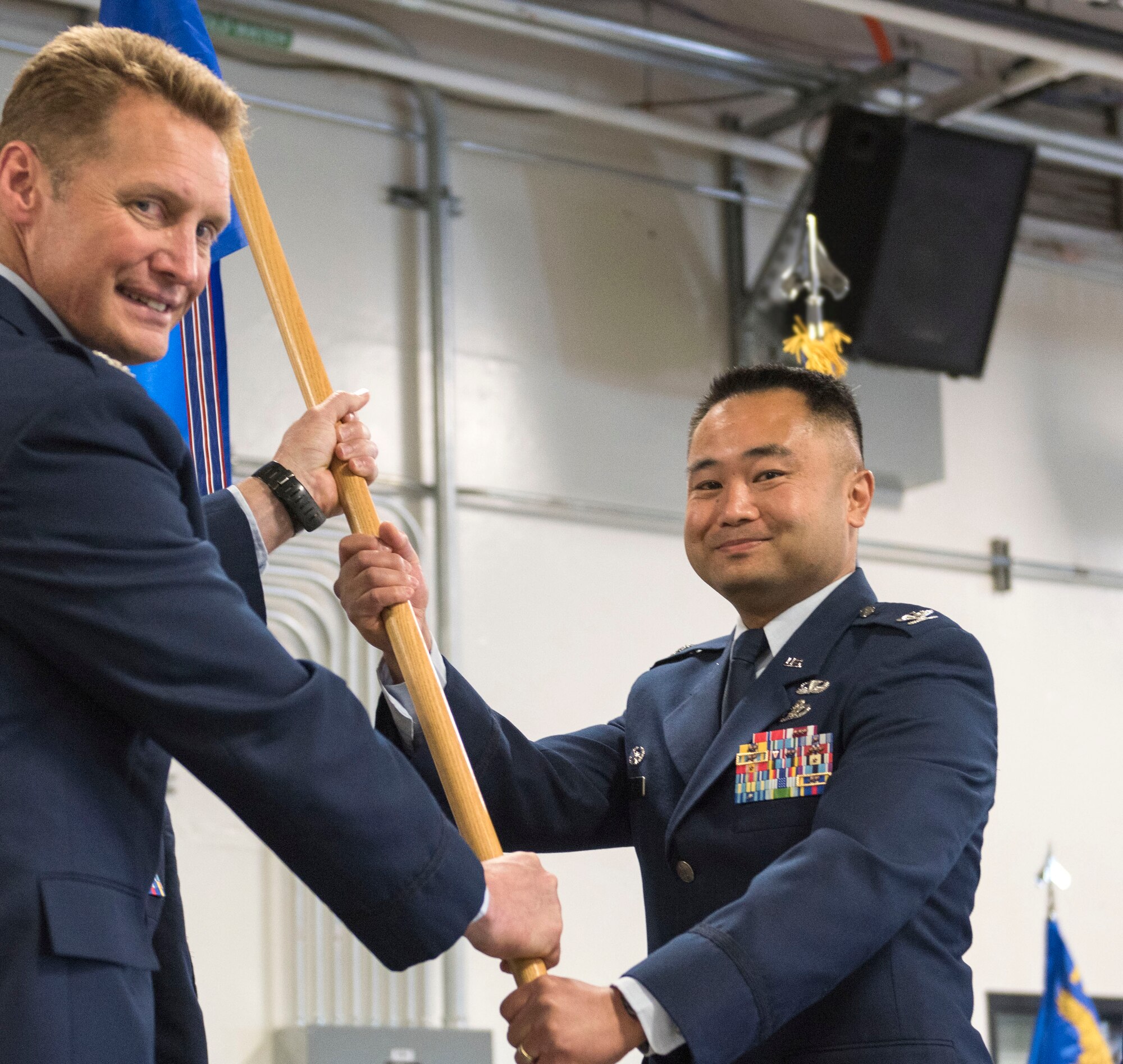 Col. Marvin T. Ee accepts the 176th Mission Support Group command flag from 176th Wing commander Col. Blake Gettys at a ceremony on Joint Base Elmendorf-Richardson. National Guard photo by Tech. Sgt. N. Alicia Halla.