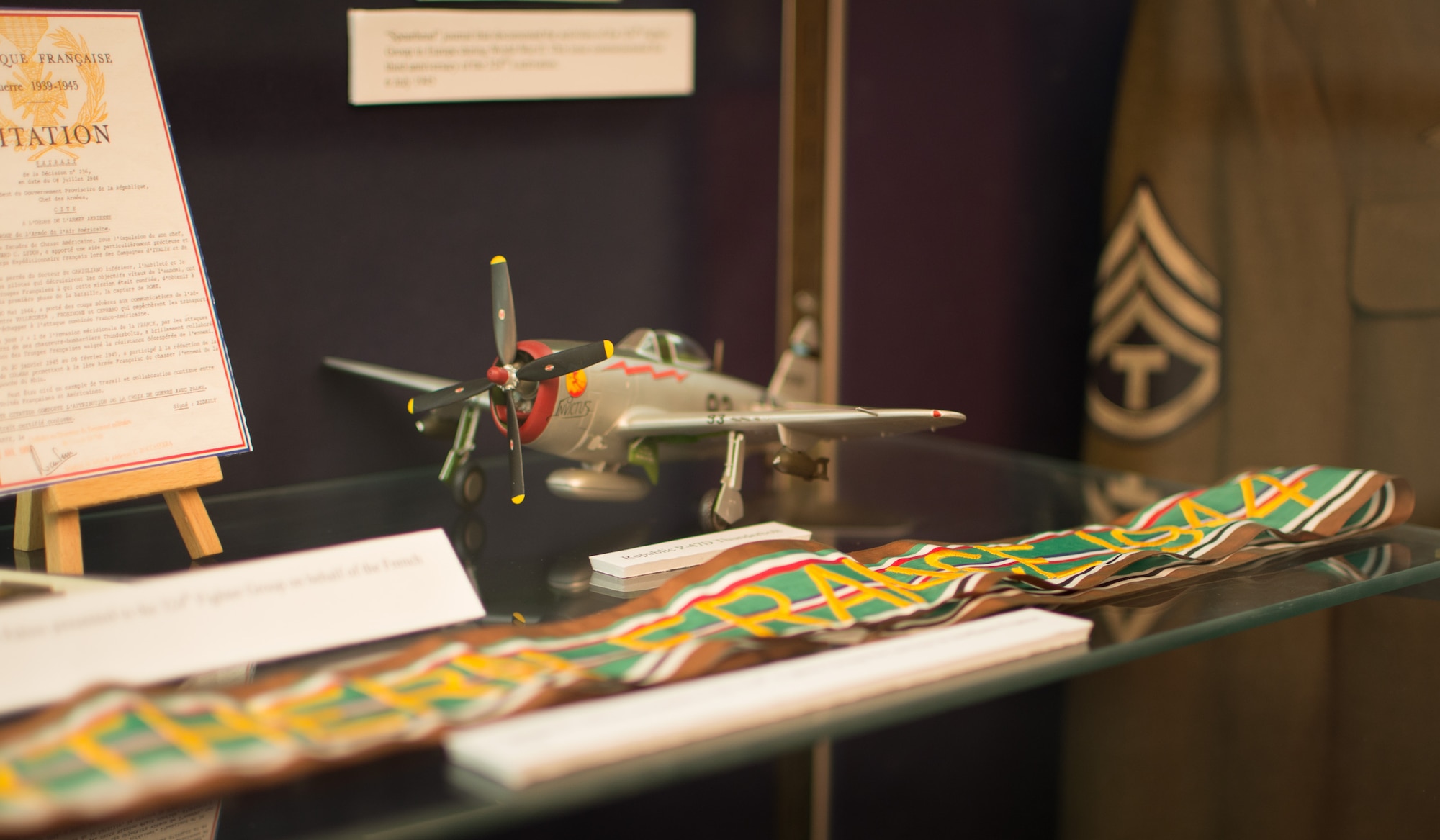 The Connecticut Air National Guard’s Flying Yankees are well into their 93rd year and the 103rd Heritage Collection located in the unit’s operations building has acquired an extensive compilation of photographs and artifacts. Recently, Maj. D. Elliotte Draegor, historian and director of inspections, assembled a display in the wing’s headquarters building outside of the dining facility. The display is comprised of various artifacts and stories she has come across in her research and it certainly catches your eye, telling the story of Gen. George P. Kane, the first person to enlist in the 118th Observation Squadron.
 (U.S. Air National Guard Photo by Airman 1st Class Sadie Hewes)