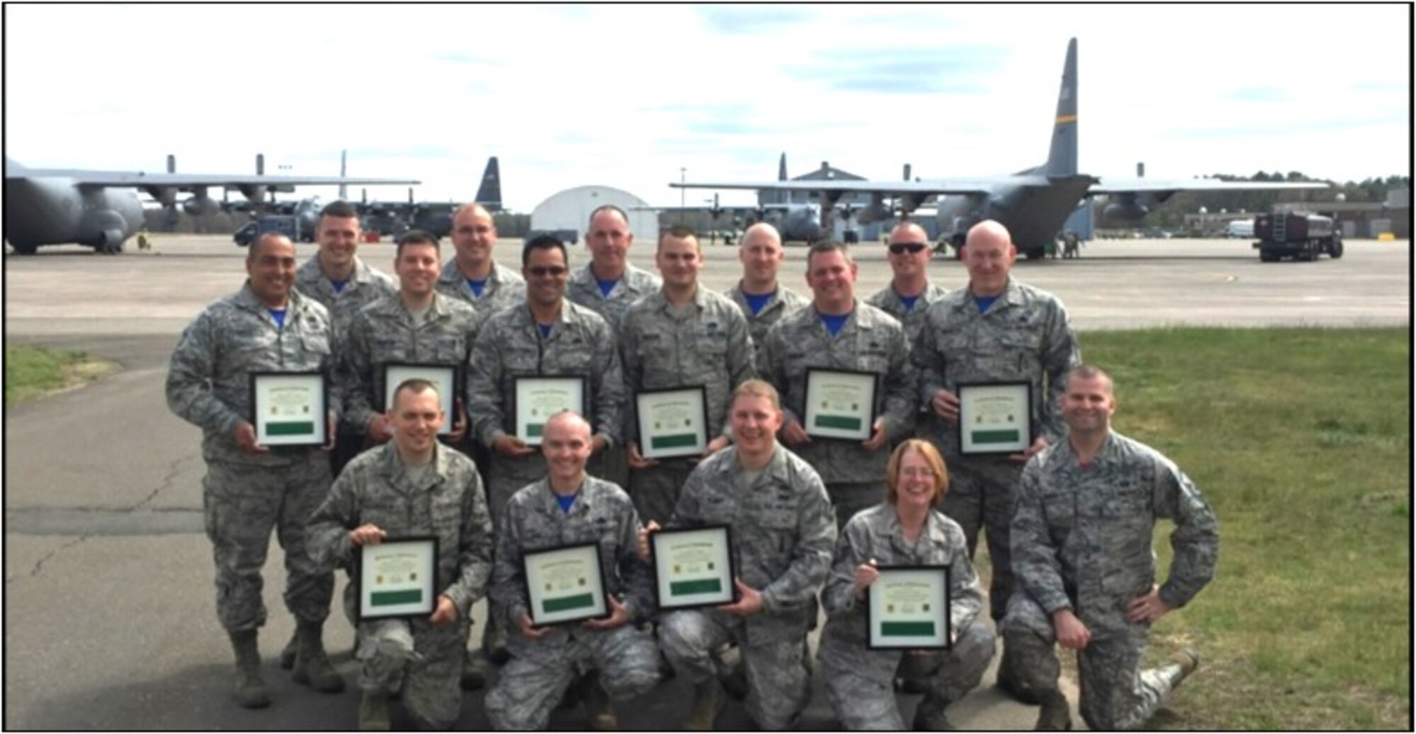 Members of the 103rd Maintenance Group proudly display their newly-earned Green Belts after graduating from a Six Sigma course taught by Master Sgt. Robert Walsh (lower right).   Walsh is a Black Belt assigned as a personnelist with the 103rd Force Support Squadron.   Six Sigma is a set of techniques and tools for process improvement used in many industrial sectors, and within the U.S. Air Force.  Green Belts are Airmen who take up Six Sigma implementation as an additional duty operating under the guidance of Black Belts.  Black Belts are seasoned Six Sigma professionals who can apply Six Sigma methodology to specific projects.  (Photo Courtesy of Capt. Cheryl Mead, 103rd Maintenance Group.) 
