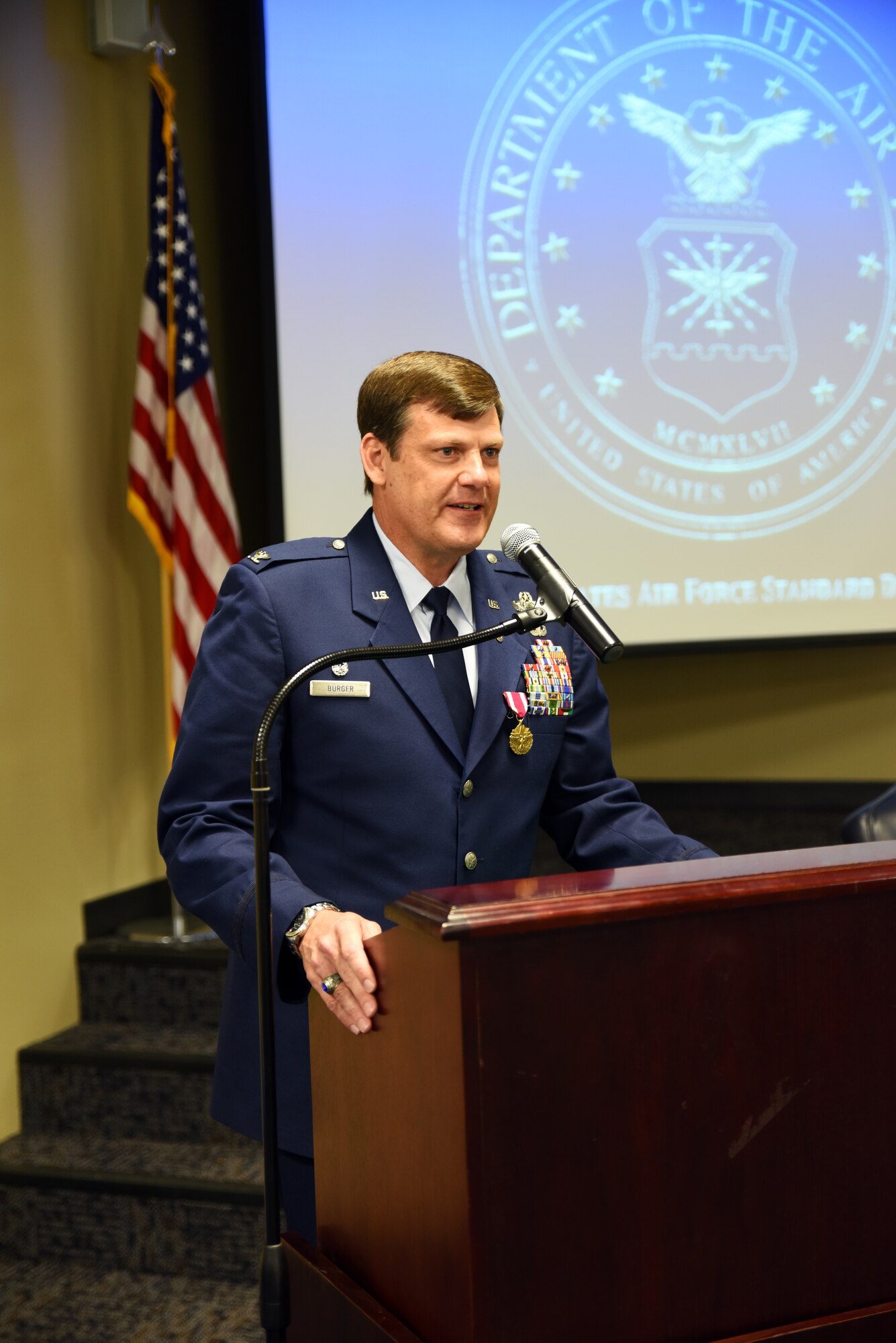 Col. Brian T. Burger, commander of the 188th Operations Group, speaks about his experiences at the 188th Wing May 15, 2016, during his formal retirement ceremony at Ebbing Air National Guard Base, Fort Smith, Ark. As a command pilot, Burger logged more than 6,100 hours of military flight during his 30 year career in numerous aircraft, including the A-10C Thunderbolt II Warthog, the wing's last aircraft. (U.S. Air National Guard photo by Senior Airman Cody Martin/Released)