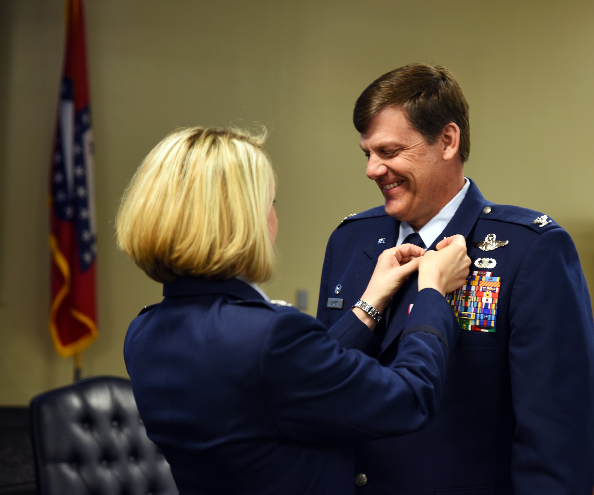 Col. Brian T. Burger, commander of the 188th Operations Group, receives a retirement pin from Col. Bobbi Doorenbos, 188th Wing commander, May 15, 2016, during a formal retirement ceremony at Ebbing Air National Guard Base, Fort Smith, Ark. As a command pilot, Burger logged more than 6,100 hours of military flight during his 30 year career in numerous aircraft, including the A-10C Thunderbolt II Warthog, the wing's last aircraft. (U.S. Air National Guard photo by Senior Airman Cody Martin/Released)