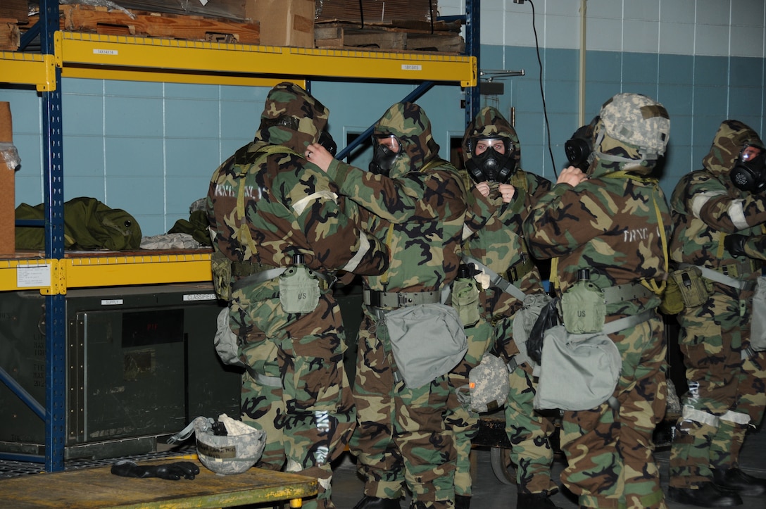 U. S. Air Force Airmen with the 186th Logistics Readiness Squadron, don their protective gear during a chemical weapons attack exercise, on Key Field Air National Guard Base, Meridian, Miss., May 15, 2016. Airmen participated in an Ability to Survive and Operate (ATSO) exercise. (U. S. Air Force Photo by Tech. Sgt. Richard L. Smith/Released)