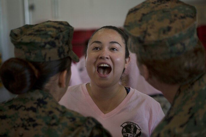 Maxine Smith, a military spouse, responds to volunteer drill instructors during the 2016 Spouse Family Day, also known as Jayne Wayne Day, at Marine Corps Air Station Iwakuni, Japan, May 14, 2016. Designed to build unit and family cohesion, this event gives insight as to what military sponsors experience daily and showcases how Marines operate and train here. Participants learned about various aspects of the Marine Corps lifestyle from strict hair regulations, fitness standards and military bearing, to how Marines operate weapons, utilize specific equipment for their jobs and different professions within the organization. (U.S. Marine Corps photo by Cpl. Justin Fisher/Released)