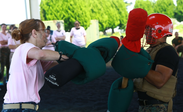 Shelly Norman, a military spouse,  fights Sgt. Jan Vazquez, airfreight non-commissioned officer in charge at the Marine Corps Air Station Iwakuni terminal, Headquarters and Headquarters Squadron, with pugil sticks during the 2016 Spouse Family Day, also known as Jayne Wayne Day at MCAS Iwakuni, Japan, May 14, 2016. Designed to build unit and family cohesion, this event gives insight as to what military sponsors experience daily and showcases how Marines operate and train here. Participants learned about various aspects of the Marine Corps lifestyle from strict hair regulations, fitness standards and military bearing, to how Marines operate weapons, utilize specific equipment for their jobs and different professions within the organization. (U.S. Marine Corps photo by Cpl. Justin Fisher/Released)