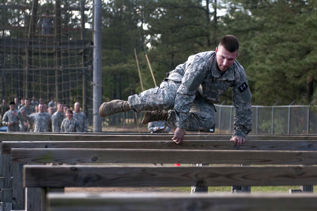 Army Spc. Christopher Elam leaps over an obstacle at the 2016 U.S. Army Reserve Best Warrior Competition at Fort Bragg, N.C., May 4, 2016. Elam is a multichannel transmission systems operator assigned to the 335th Signal Command Theater. Army photo by William K. Gillespie