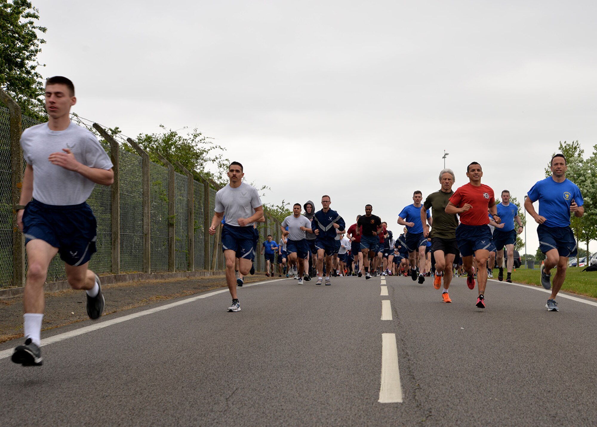 Team Mildenhall members take part in the monthly 5 km run May 13, 2016, on Perimeter Road near the Hardstand Fitness Center on RAF Mildenhall, England. The run is mandatory for all 100th Air Refueling Wing military personnel, but is open to tenant units and base ID cardholders. (U.S. Air Force photos by Karen Abeyasekere/Released)
