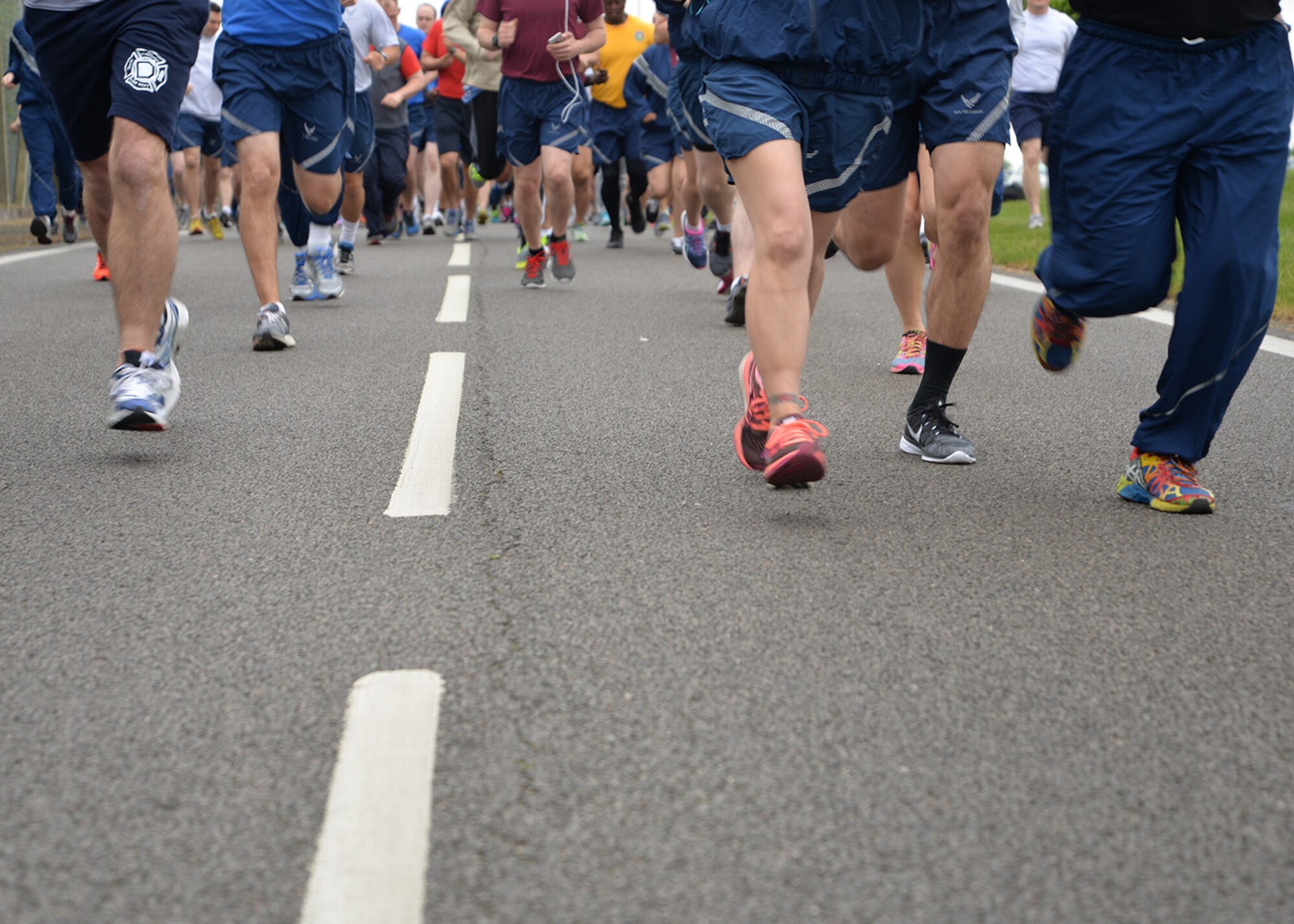 Team Mildenhall members take part in the monthly 5 km run May 13, 2016, on Perimeter Road near the Hardstand Fitness Center on RAF Mildenhall, England. The run is mandatory for all 100th Air Refueling Wing military personnel, but is open to tenant units and base ID cardholders. (U.S. Air Force photos by Karen Abeyasekere/Released)