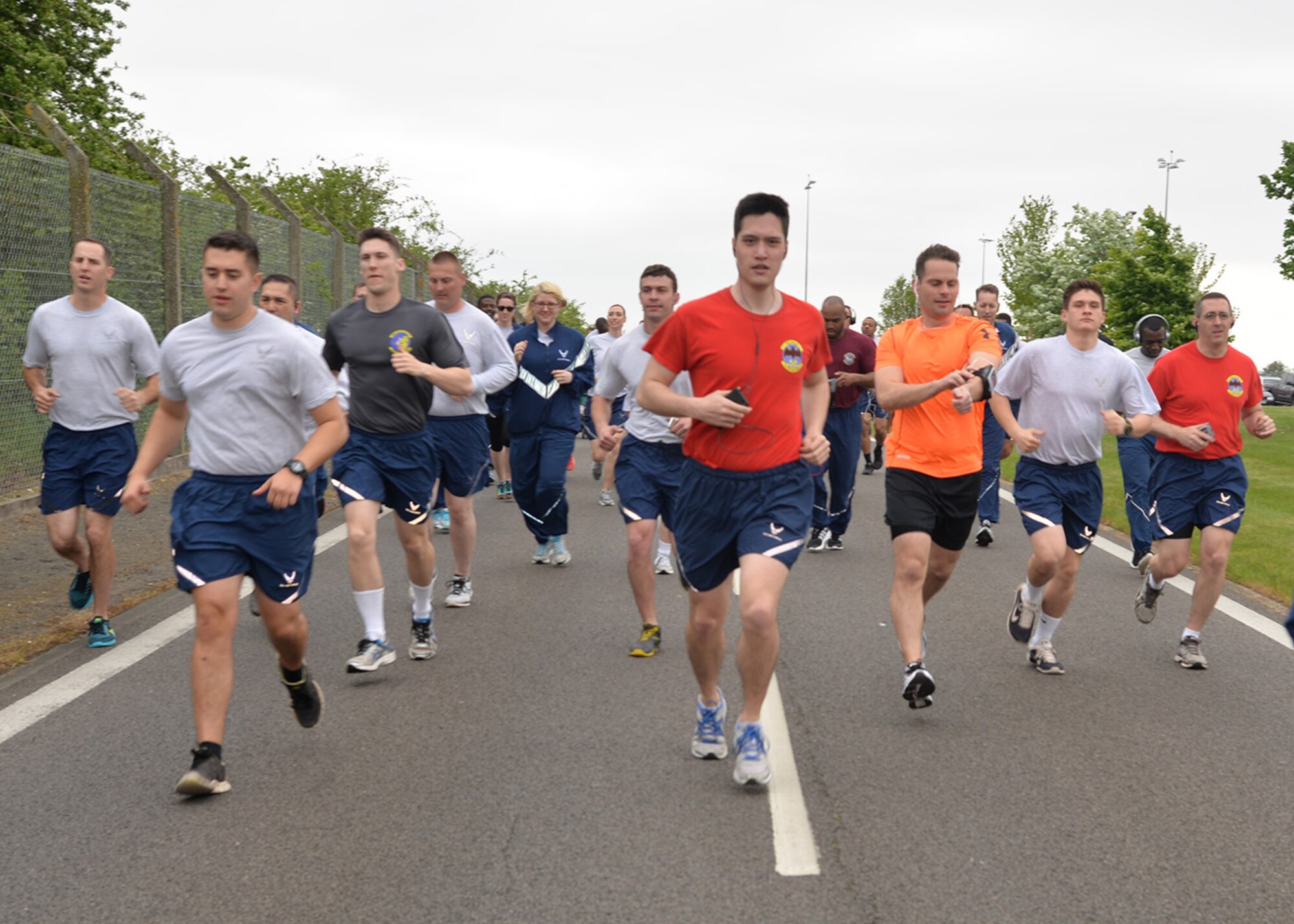 Team Mildenhall members take part in the monthly 5 km run May 13, 2016, on Perimeter Road near the Hardstand Fitness Center on RAF Mildenhall, England. The run is mandatory for all 100th Air Refueling Wing military personnel, but is open to tenant units and base ID cardholders. (U.S. Air Force photos by Karen Abeyasekere/Released)