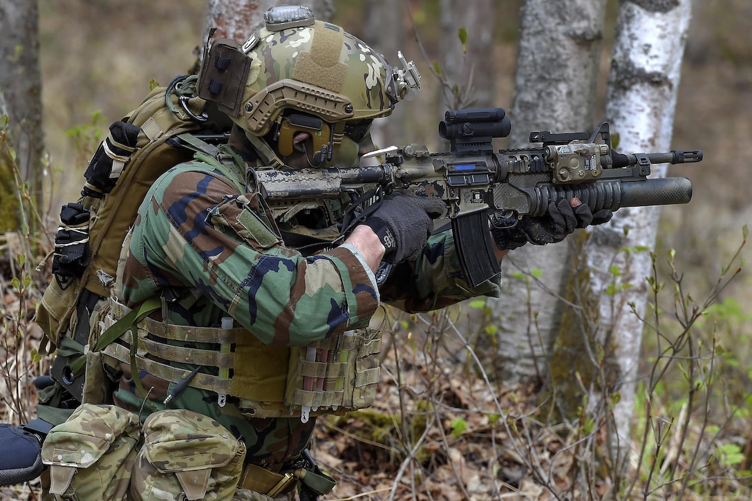 A pararescueman engages opposition forces during mass casualty search and rescue training at Joint Base Elmendorf-Richardson, Alaska, May 4, 2016. Air Force photo by Alejandro Pena 