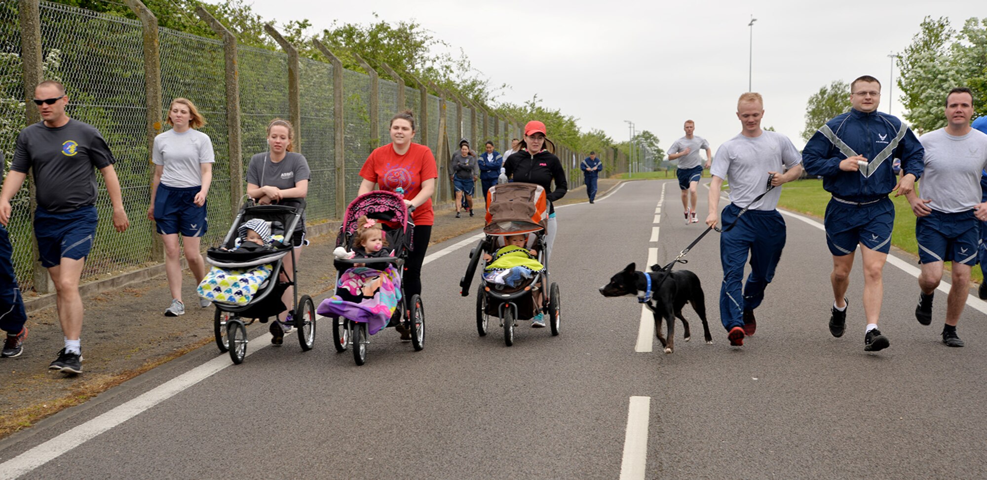 Team Mildenhall members take part in the monthly 5 km run May 13, 2016, on Perimeter Road near the Hardstand Fitness Center on RAF Mildenhall, England. The run is mandatory for all 100th Air Refueling Wing military personnel, but is open to tenant units and base ID cardholders. (U.S. Air Force photos by Karen Abeyasekere/Released)
