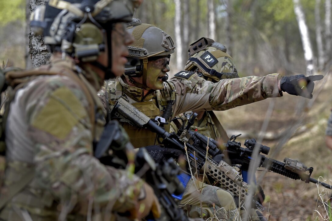 Pararescuemen prepare to assault an enemy position during mass casualty search and rescue training at Joint Base Elmendorf-Richardson, Alaska, May 4, 2016. Air Force photo by Alejandro Pena 