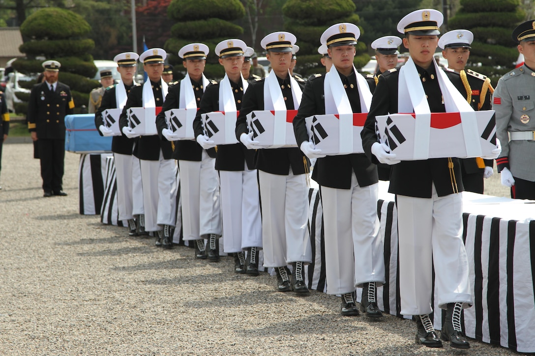 Pallbearers hold the caskets of the fallen Soldiers during a repatriation ceremony on the Knight Field, in Seoul, South Korea, April 28. The ceremony was conducted to return remains of United Nations Command and Korean Soldiers who died on the field of battle during the Korean War. 
