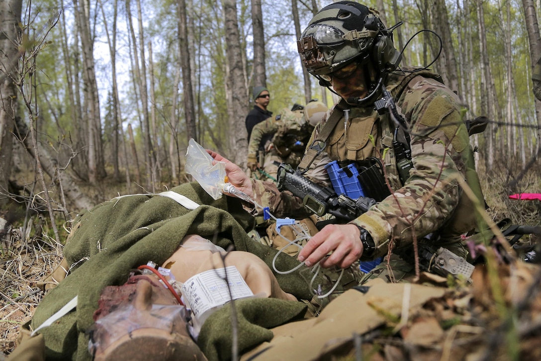 A pararescueman treats a simulated casualty during mass casualty search and rescue training at Joint Base Elmendorf-Richardson, Alaska, May 4, 2016. Air Force photo by Alejandro Pena 