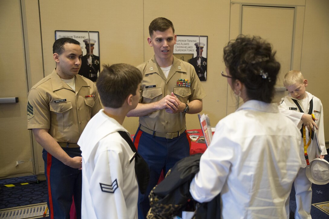 Sergeant Francisco Martinez, left, and Capt. Wesley Jagoe speak with a student and his mother about engineering opportunities in the Marine Corps during the Naval STEM Exposition in Fort Washington, Md. May 15, 2016. The Marine Corps recognizes the event as a valuable opportunity to foster positive relationships with students, share the Marine story, and reinforce the idea of the armed services as a viable career option. Martinez is apart of reserve support with Marine Corps Recruiting Command. Jagoe is a reserve support officer for Recruiting Station Frederick. 
