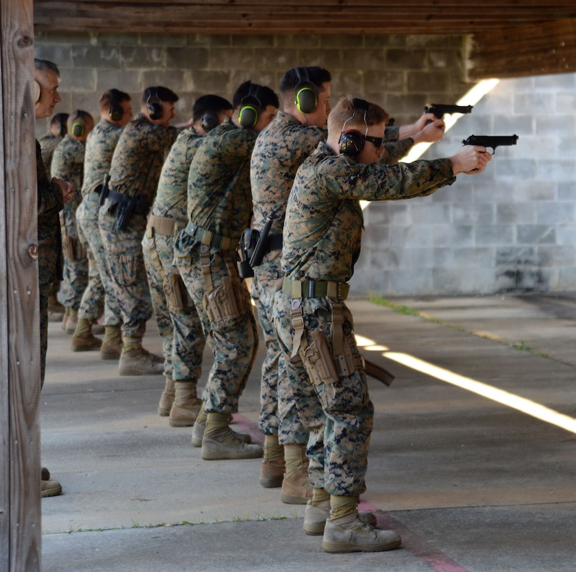Active-duty service members and Marine Corps police officers “take aim” in one of several Combat Pistol Program training courses officials host at Marine Corps Logistics Base Albany’s pistol range throughout the year. As the combat marksmanship coach looked on, shooters fired live rounds at targets during their course of fire qualification. The CPP is a five-day training course held on the installation’s pistol range to facilitate annual qualification requirements for service members and law enforcement personnel.