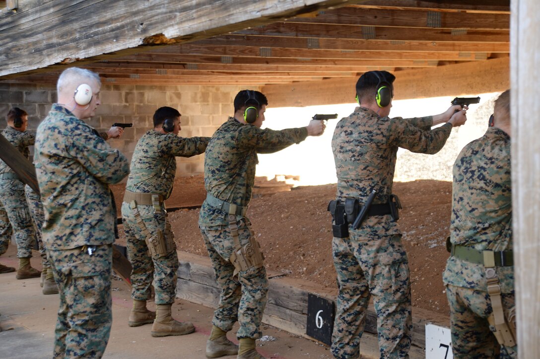 Active-duty service members and Marine Corps police officers “take aim” in one of several Combat Pistol Program training courses officials host at Marine Corps Logistics Base Albany’s pistol range throughout the year. As the combat marksmanship coach looked on, shooters fired live rounds at targets during their course of fire qualification. The CPP is a five-day training course held on the installation’s pistol range to facilitate annual qualification requirements for service members and law enforcement personnel.