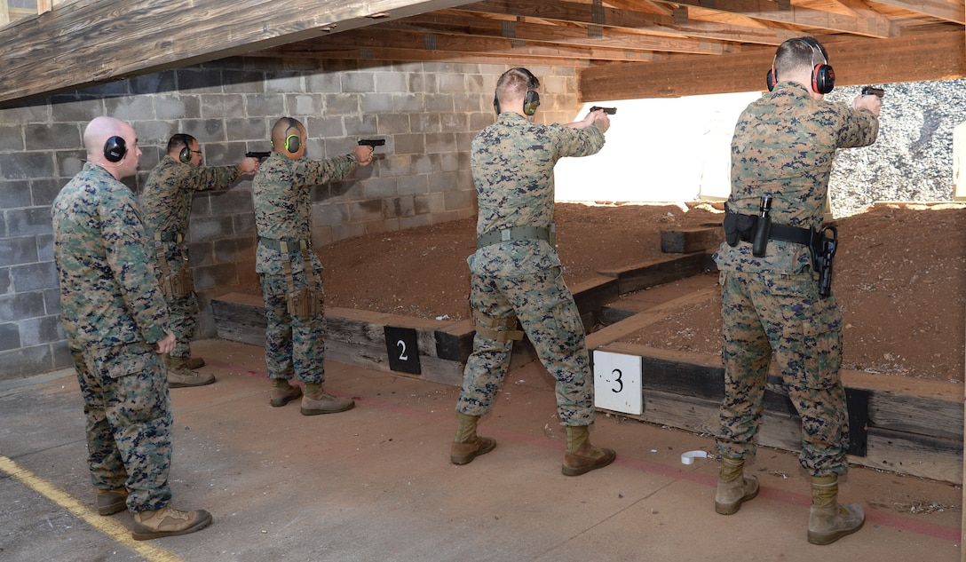 Active-duty service members and Marine Corps police officers “take aim” in one of several Combat Pistol Program training courses officials host at Marine Corps Logistics Base Albany’s pistol range throughout the year. As the combat marksmanship coach looked on, shooters fired live rounds at targets during their course of fire qualification. The CPP is a five-day training course held on the installation’s pistol range to facilitate annual qualification requirements for service members and law enforcement personnel.