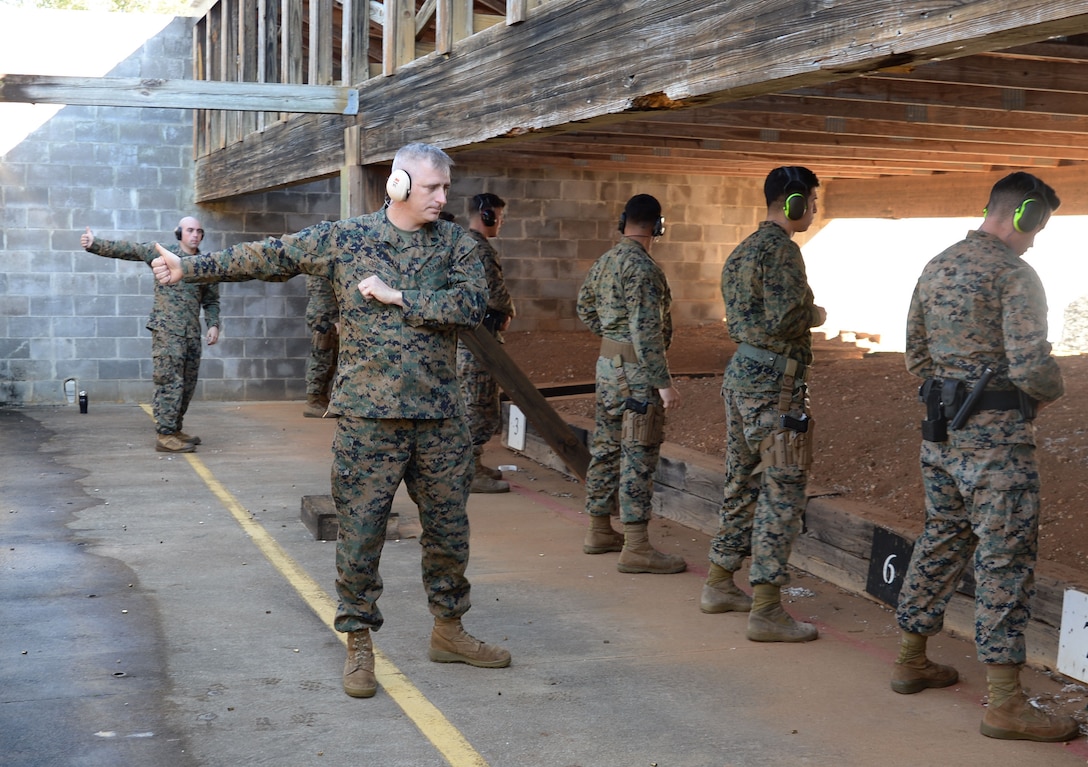 Combat marksmanship coaches give the “all-clear” thumbs up after active-duty service members and Marine Corps police officers holster their weapons during one of several Combat Pistol Program training courses officials host at Marine Corps Logistics Base Albany’s pistol range throughout the year. Shooters fired live rounds at targets as part of their annual course of fire qualification requirement. The CPP is a five-day course held on the installation’s pistol range to facilitate training for service members and law enforcement personnel.