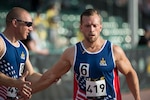Air Force Tech. Sgt. Benjamin Seekell congratulates Maryland Air National Guard  Staff Sgt. Gideon Connelly after they finish the 200-meter dash during the track and field competition at the Invictus Games at the ESPN Wide World of Sports complex, Walt Disney World, Orlando, Fla., May 10, 2016. The Invictus Games are the United Kingdom’s version of the Warrior Games, bringing together wounded veterans from 14 nations for events including track and field, archery, wheelchair basketball, road cycling, indoor rowing, wheelchair rugby, swimming, sitting volleyball and a driving challenge. 