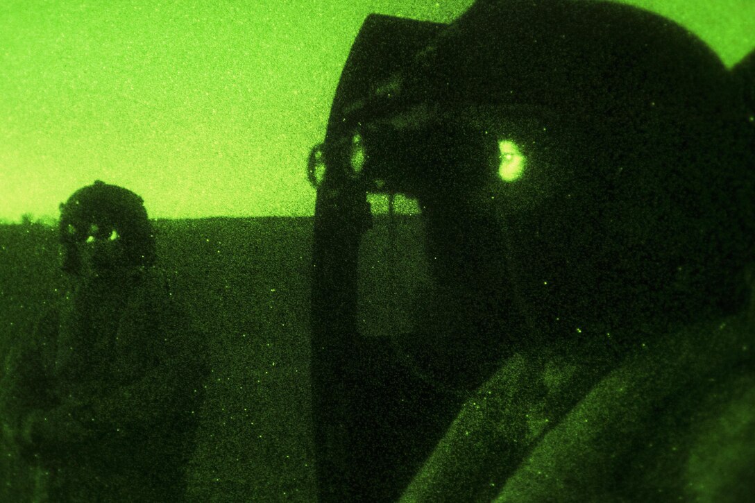Army crew chiefs check their night-vision goggles before a mission during Emerald Warrior 16 at Hurlburt Field, Fla., May 5, 2016. Air Force photo by Staff Sgt. Paul Labbe
