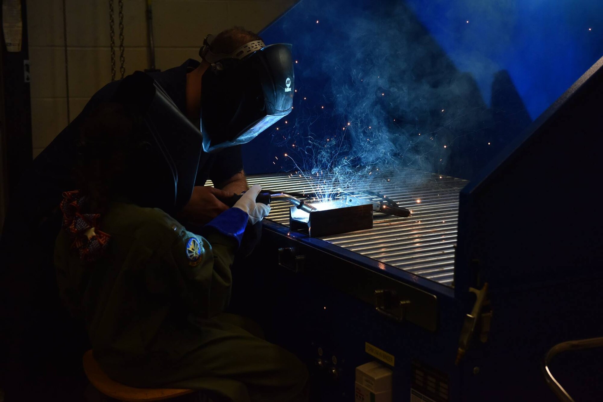 12 year-old Norah Carter, honorary second lieutenant of the 911th Airlift Wing, welds under the supervision of Tech Sgt. Joe Davis, metals technician with the 911th Maintenance Squadron at the Pittsburgh International Air Reserve Station, May 11, 2016. Norah was nominated for the Pilot for a Day program by her doctors with the Allegheny Health Network, where she is being treated for an undiagnosed genetic disorder. (U.S. Air Force Photo by 2nd Lt. Jacob Morgan)